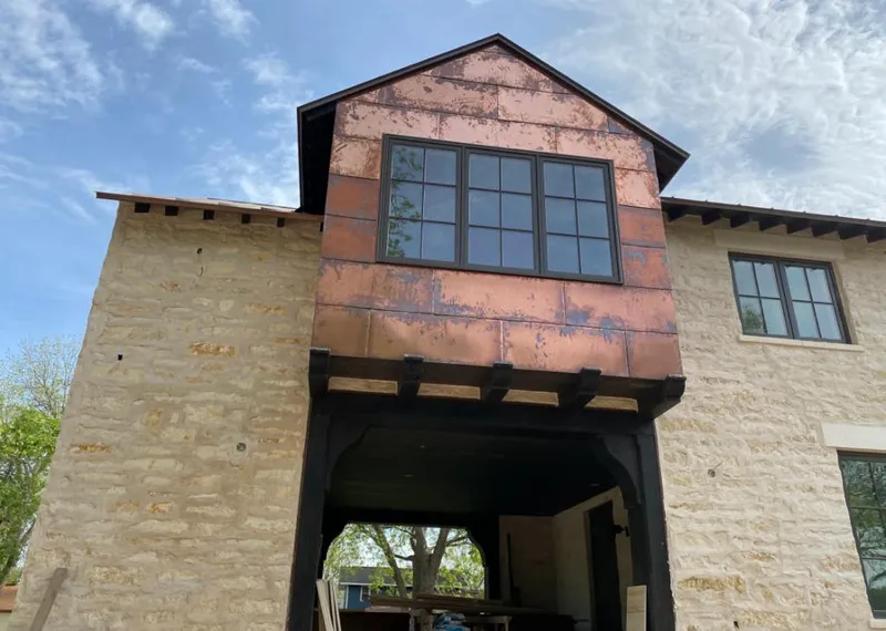 Copper metal panel facade on a stone building for Skylight Installation in Grand Junction