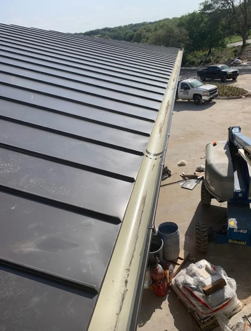 Standing seam panel and gutter detail on a metal roofing jobsite in Grand Junction